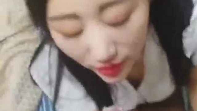 A slutty young woman in a sexy black stocking short skirt is having sex with two people, oral sex and footjob. She takes off her black stockings and gets fucked from behind. She rides on top and moves herself.