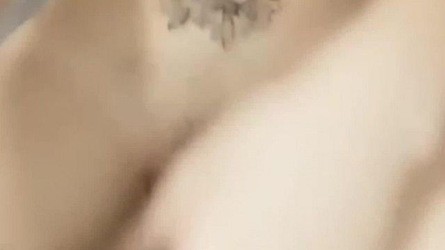 A beautiful girl with a devilish figure shaves her pussy and fucks her pussy with a big black rubber rod for a live broadcast